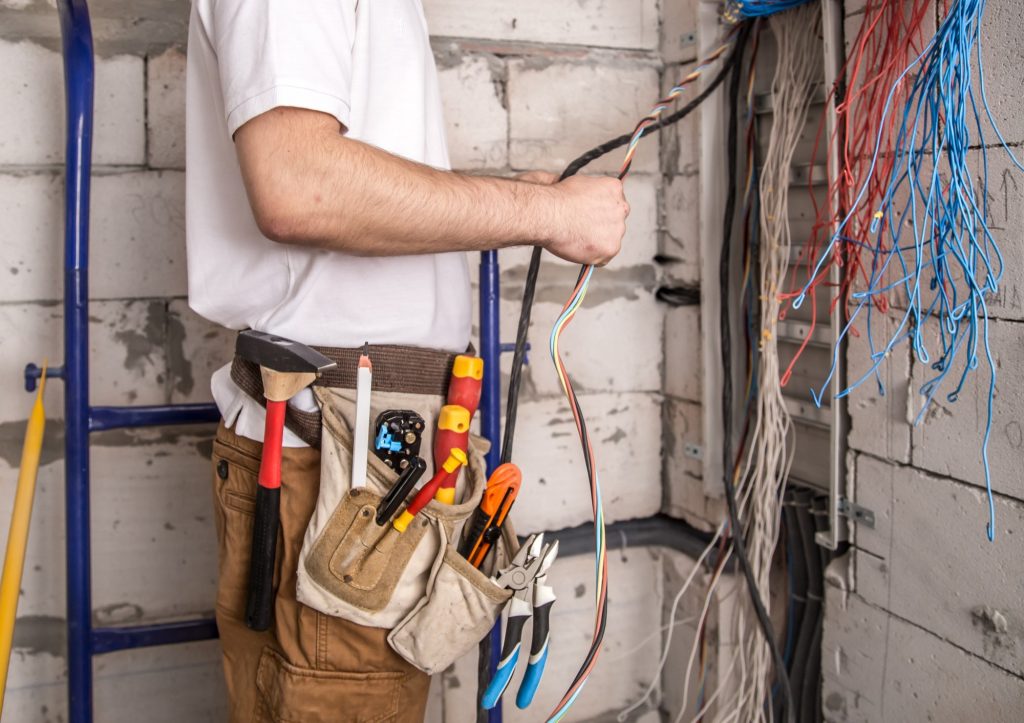 electrician-working-near-board-with-wires-instsaallation-connection-electrics-1.jpg